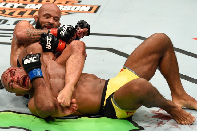 KANSAS CITY, MO - APRIL 15: (L-R) Demetrious Johnson submits Wilson Reis of Brazil in their UFC flyweight fight during the UFC Fight Night event at Sprint Center on April 15, 2017 in Kansas City, Missouri. (Photo by Josh Hedges/Zuffa LLC/Zuffa LLC via Getty Images)